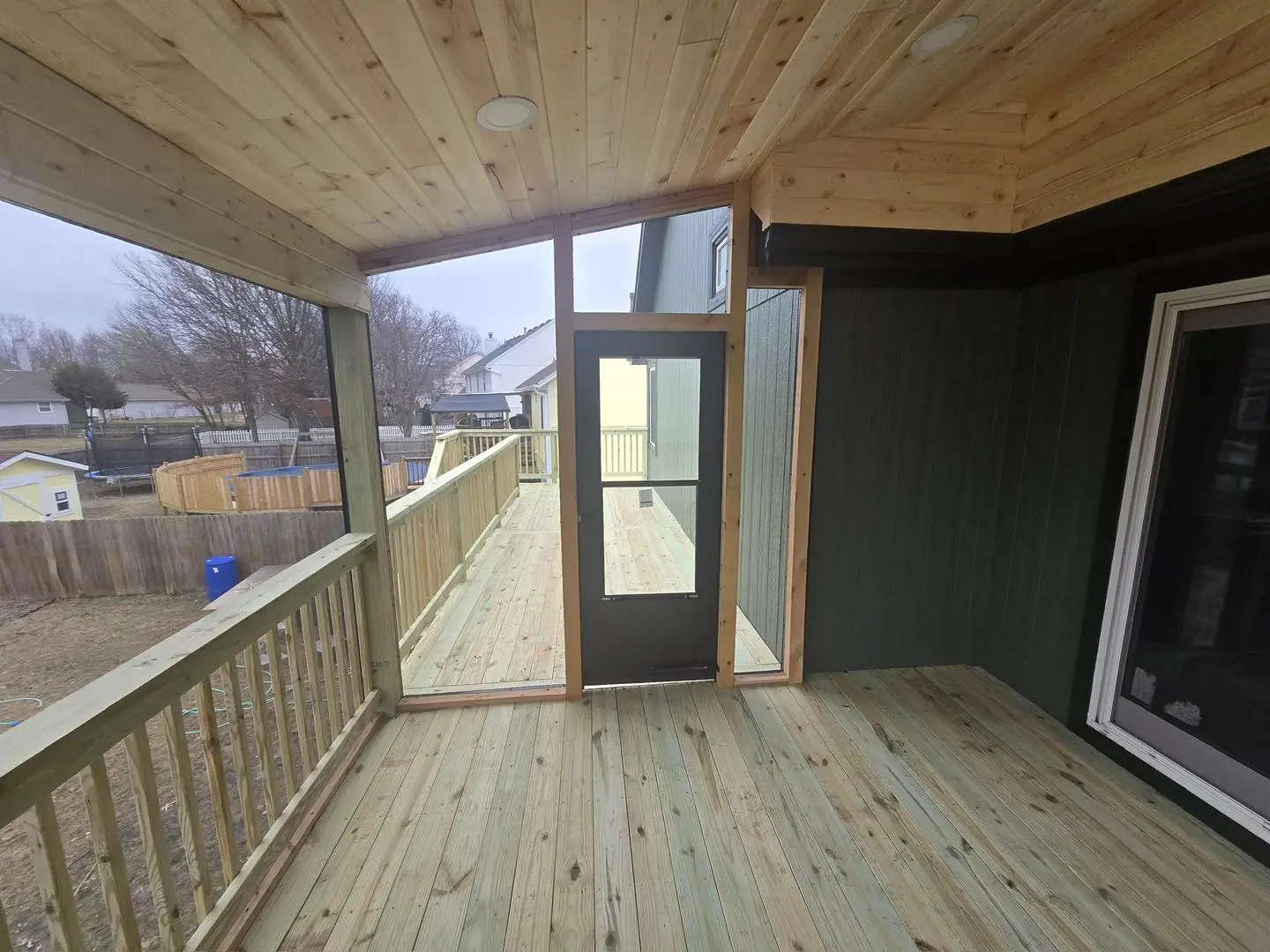 well-maintained elevated covered deck with screen door showing results of seasonal deck maintenance tips