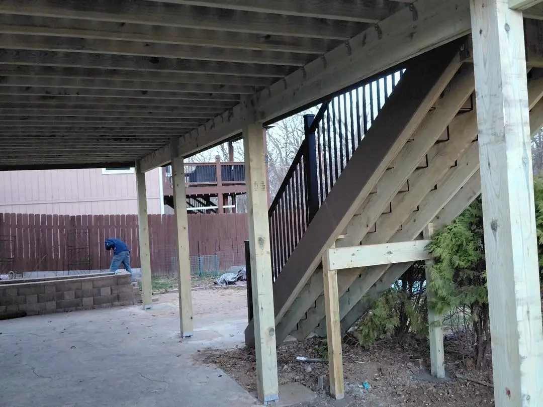 elevated deck construction showing stair framing by professional deck builder in Kansas City area