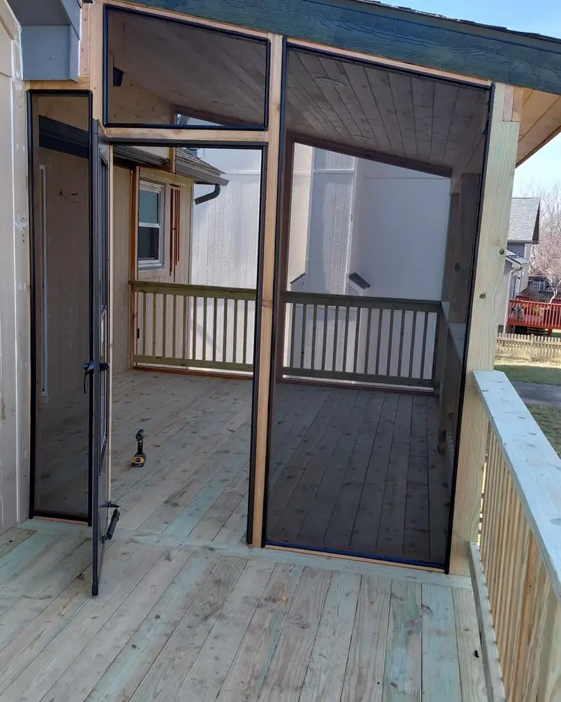 screened elevated wood deck with railings demonstrating deck maintenance tips for summer protection